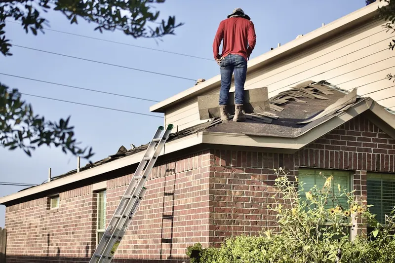 Professional roofer working on a residential roof in Bluffton
